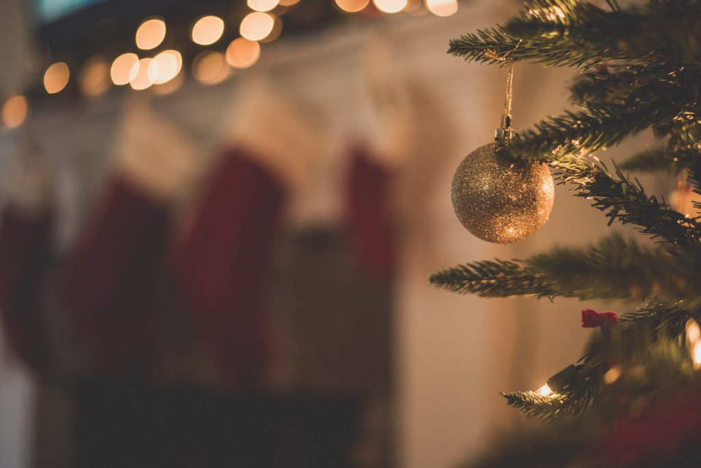 Christmas tree with one gold sparkly ornament