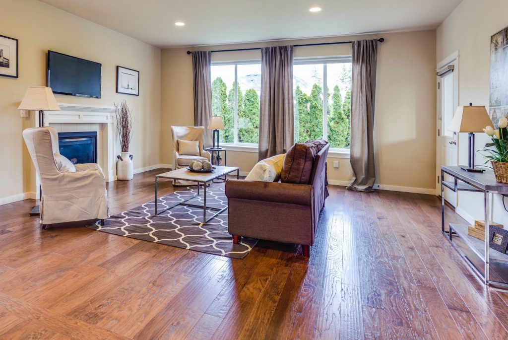 living room with furniture and tall windows with open curtains